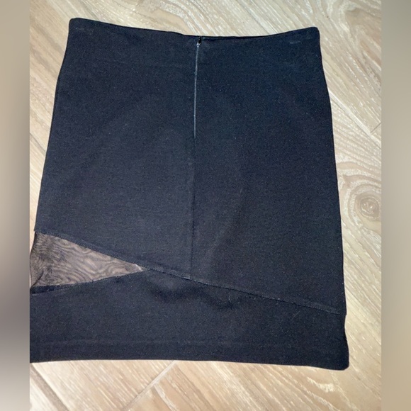 Black mini skirt BB Dakota featuring a unique diagonal sheer mesh panel detail.4 - Picture 5 of 8